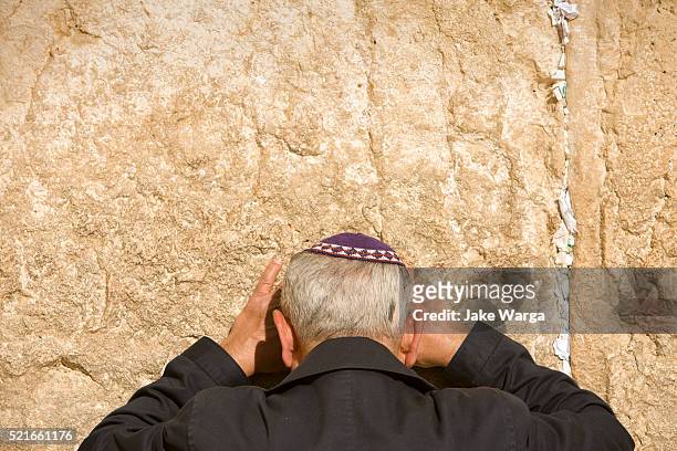 man preying, the western wall, wailing wall or kotel, old jerusalem, israel - wailing wall stock pictures, royalty-free photos & images
