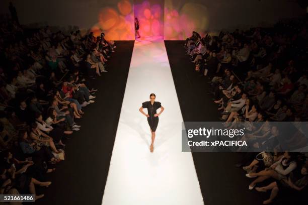 model on runway at a fashion show - fashion show ramp stock pictures, royalty-free photos & images