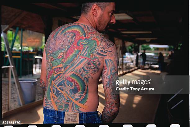 man with a tattooed back - white dragon tattoo stock pictures, royalty-free photos & images