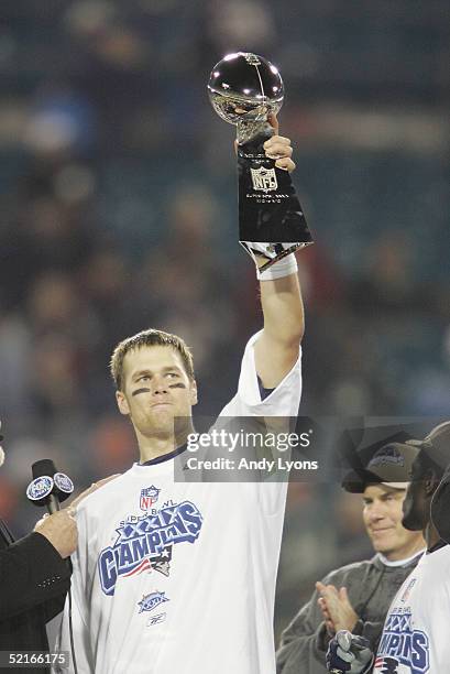 Quarterback Tom Brady of the New England Patriots holds up the Lombardi Trophy after defeating the Philadelphia Eagles in Super Bowl XXXIX at Alltel...