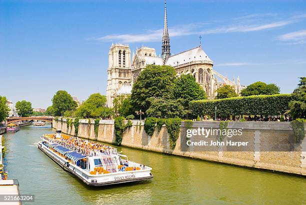 notre dame cathedral and pleasure boat on seine river - seine maritime stock pictures, royalty-free photos & images