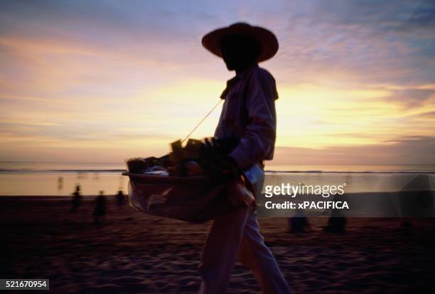 vendor selling items on beach - kuta stock pictures, royalty-free photos & images