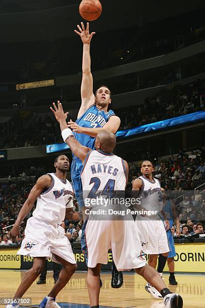 Michael Bradley of the Orlando Magic shoots over Jarvis Hayes of the Washington Wizards during the game on November 10, 2004 at the MCI Center in...