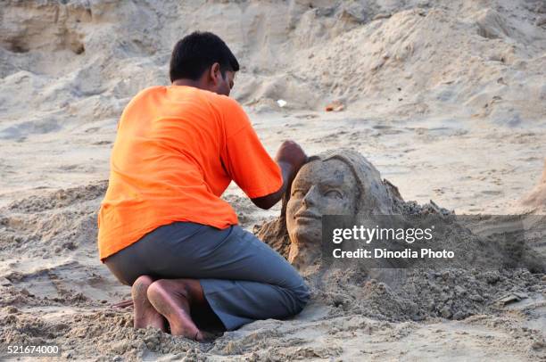 sand art at puri beach, orissa, india - sand sculpture stockfoto's en -beelden