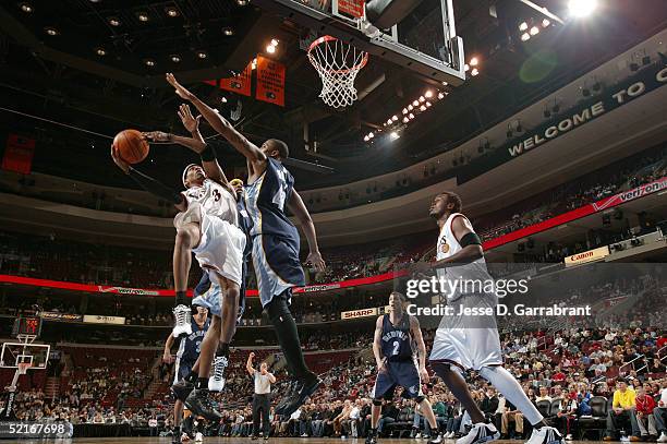 Allen Iverson of the Philadelphia 76ers shoots against Lorenzen Wright of the Memphis Grizzlies on February 9, 2005 at the Wachovia Center in...