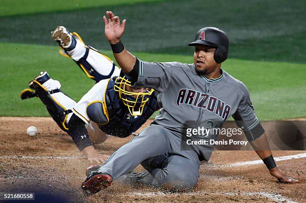 Yasmany Tomas of the Arizona Diamondbacks scores ahead of the tag of Derek Norris of the San Diego Padres during the seventh inning of a baseball...