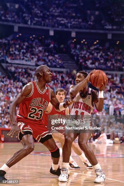 Isiah Thomas of the Detroit Pistons stops his drives against Michael Jordan of the Chicago Bulls during an NBA game in 1988 at The Palace in Auburn...