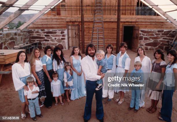 Polygamist Alex Joseph stands with his numerous wives and children.