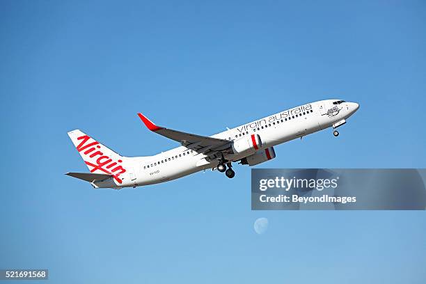 virgin over the moon: plane taking-off with moonrise. - virgin plane stock pictures, royalty-free photos & images