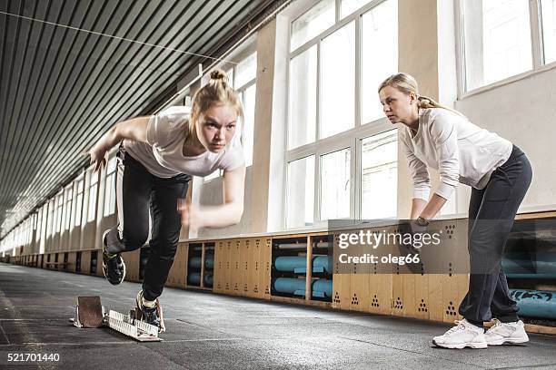 jogging in a gym - running coach stock pictures, royalty-free photos & images