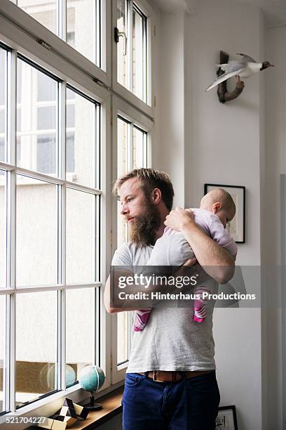 young father with newborn baby - contemplation family stockfoto's en -beelden