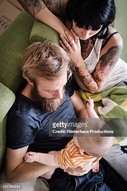 young family relaxing with newborn baby - baby beard stock-fotos und bilder