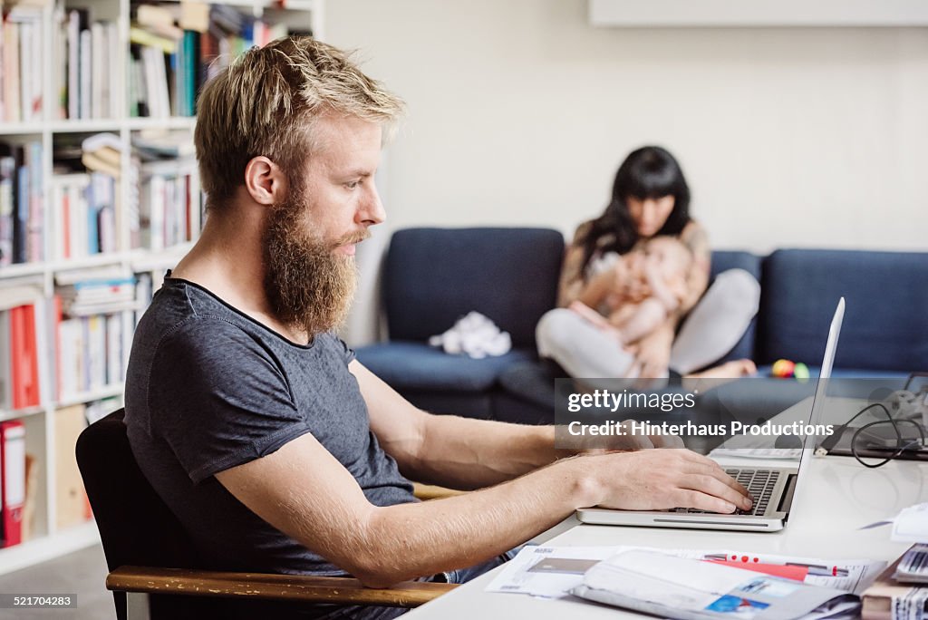 Young Father Working At Home Office