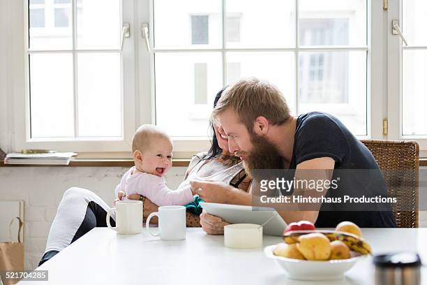 young family with baby having fun - happy couple kitchen stock pictures, royalty-free photos & images