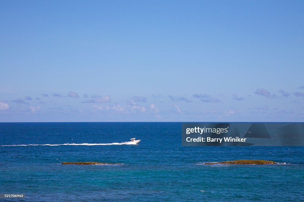 Boat moving through blue water, San Juan