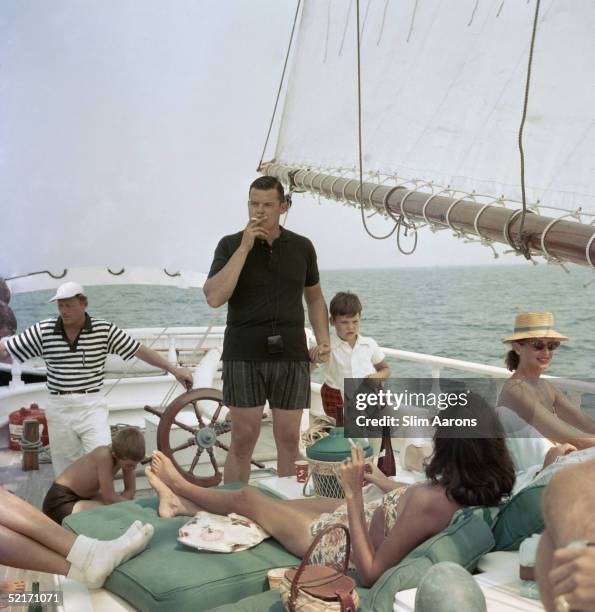 Henry B. Cabot Jr. With his son Henry Bromfield Cabot III and their host Barclay H Warburton III aboard the brigantine 'Black Pearl', circa 1959....