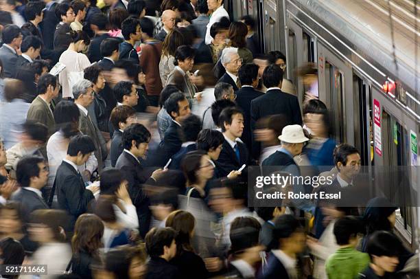 commuters rushing onto train at umeda subway station in osaka - crowd foto e immagini stock