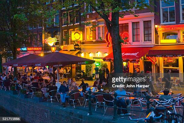 sidewalk cafe in red light district of amsterdam - amsterdam cafe stock pictures, royalty-free photos & images