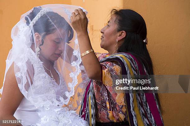 bride's mom adusts veil - guatemala family stock pictures, royalty-free photos & images