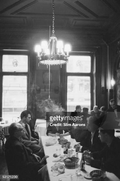 Photographers' luncheon in New York, early 1950s. Present are Gjon Mili, Ernst Haas, Elliott Erwitt, David 'Chim' Seymour and W. Eugene Smith.
