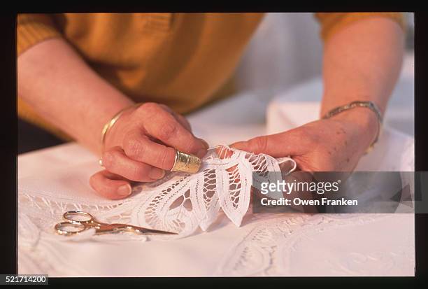 lacemaker attaching lace to a tablecloth - lace making stock pictures, royalty-free photos & images