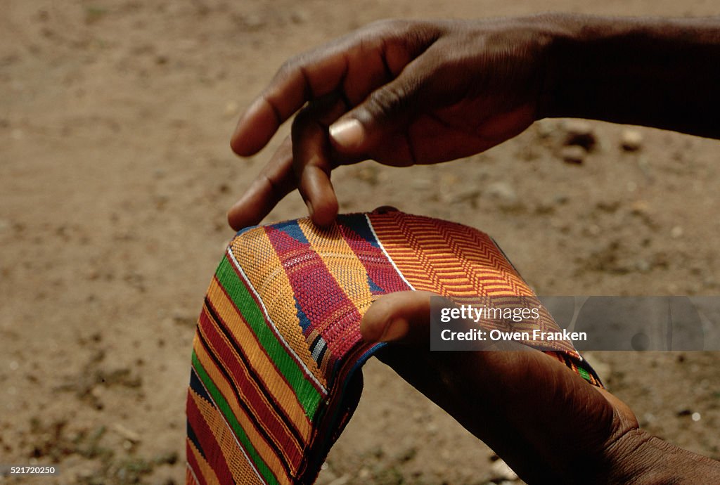 Hands Holding a Kente Cloth