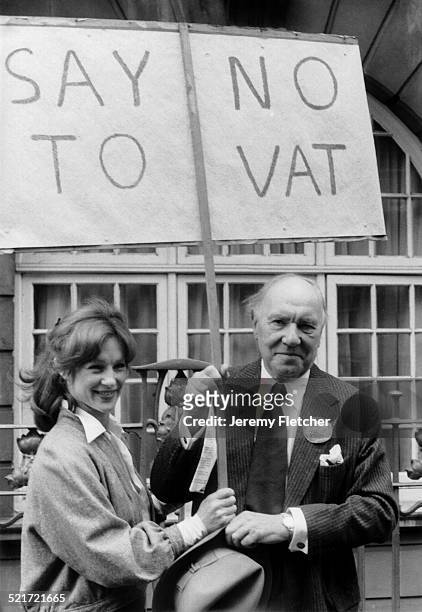 English actors Sir Ralph Richardson and Shirley Anne Field at an anti-VAT march, London, 1979. Their placard reads 'Say No To VAT'.