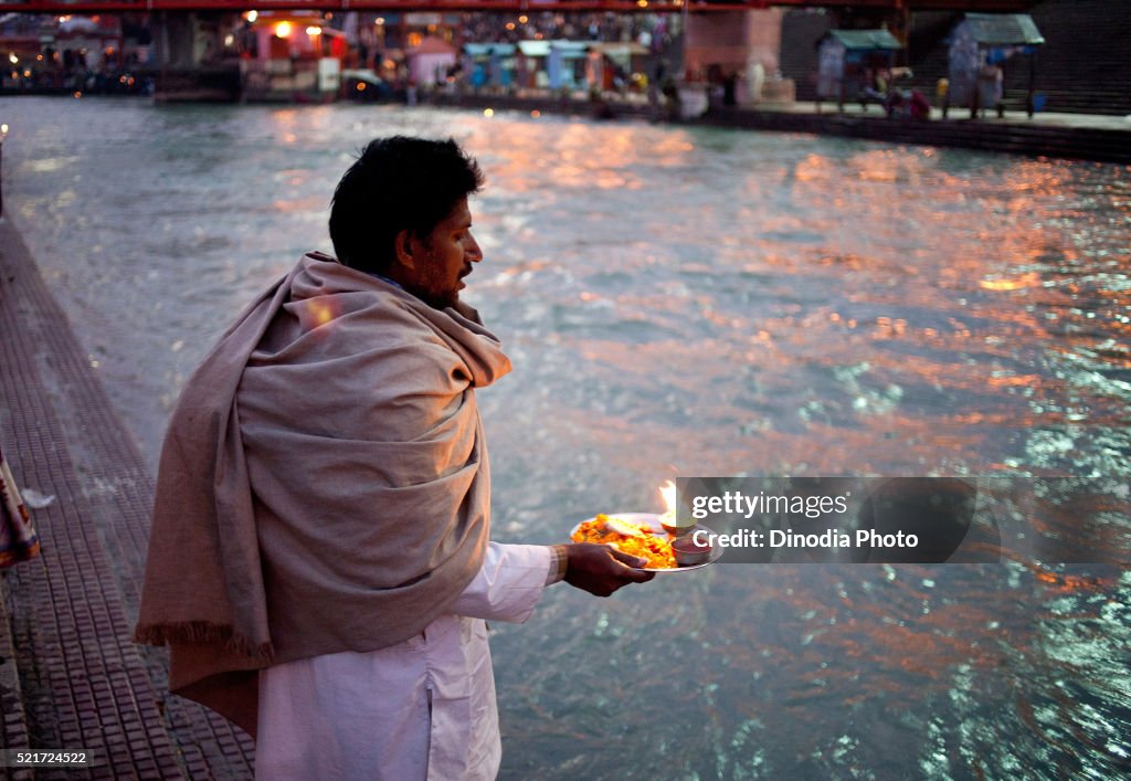 Man performing pooja of river Ganga at Haridwar, Uttarakhand, India, Asia