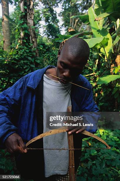 baka man adjusting crossbow - cameroon forest stock pictures, royalty-free photos & images