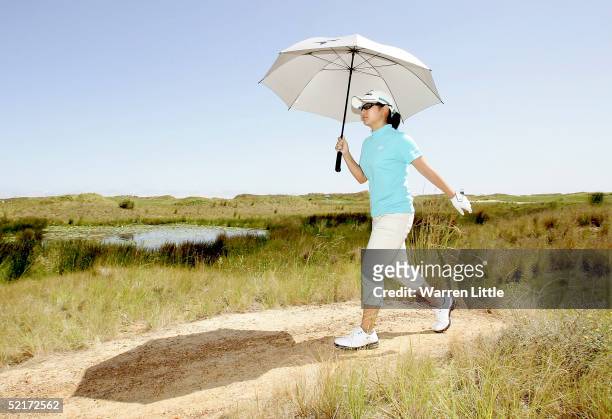Ai Miyazato of Japan walks from the fifth tee box during the pro-am of the 2005 Women's World Cup of Golf on the Links course at Fancourt Golf &...