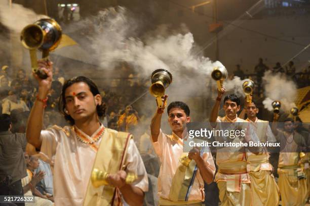 india, uttar pradesh, varanasi, offering of incense to the ganges - caste stock pictures, royalty-free photos & images