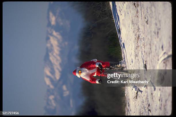 santa claus bicycles the olympic mountains - santa riding stock pictures, royalty-free photos & images