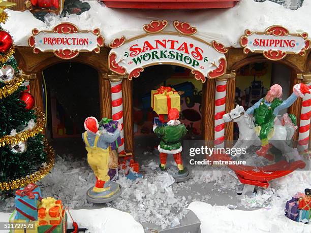 model christmas village with miniature houses, people, winter-scene, santa's workshop - elf workshop stock pictures, royalty-free photos & images