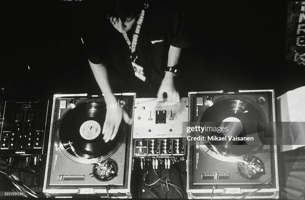 Disc jockey at turntables