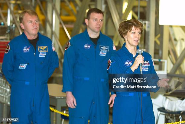 Commander Eileen Collins speaks as her crew members, pilot James Kelly and mission specialist Andrew Thomas , listen as astronauts with space shuttle...