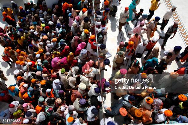 crowds of devotees in queues during festival of hola mohalla at anandpur sahib gurudwara in rupnagar district, punjab, india - punjab aerial view stock pictures, royalty-free photos & images