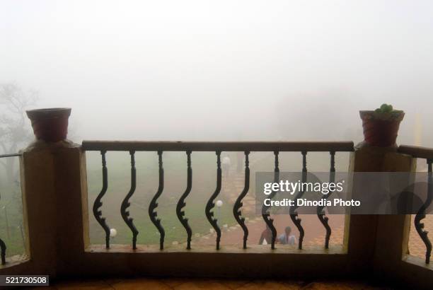 heavy mist view from balcony, malshej ghat, maharashtra, india - malshej ghat stockfoto's en -beelden