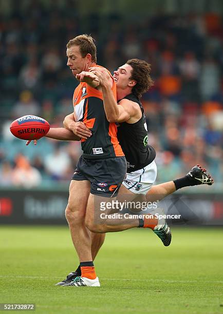 Steve Johnson of the Giants is tackled by Darcy Byrne-Jones of the Power during the round four AFL match between the Greater Western Sydney Giants...