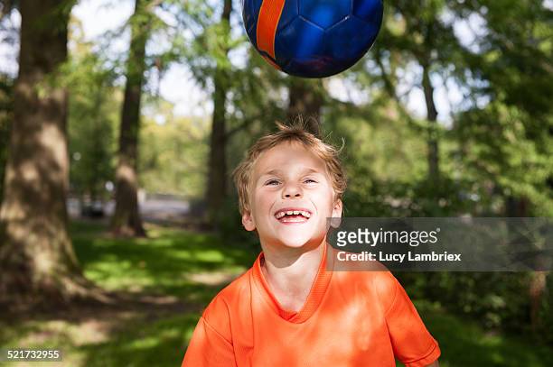 happy boy playing with soccer ball - 6 football player stock-fotos und bilder