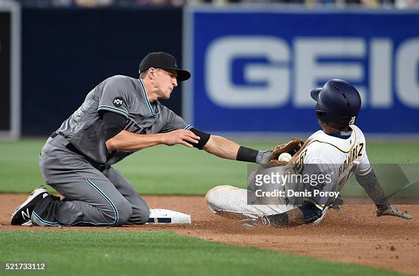 Alexei Ramirez of the San Diego Padres is tagged out by Nick Ahmed of the Arizona Diamondbacks as he tries to steal second base during the ninth...