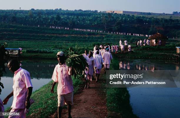 Prisoners accused of the genocide in 1994 walk to work in a brick-making factory or in the fields outside Butare Prison in Butare, Rwanda. 800,000...