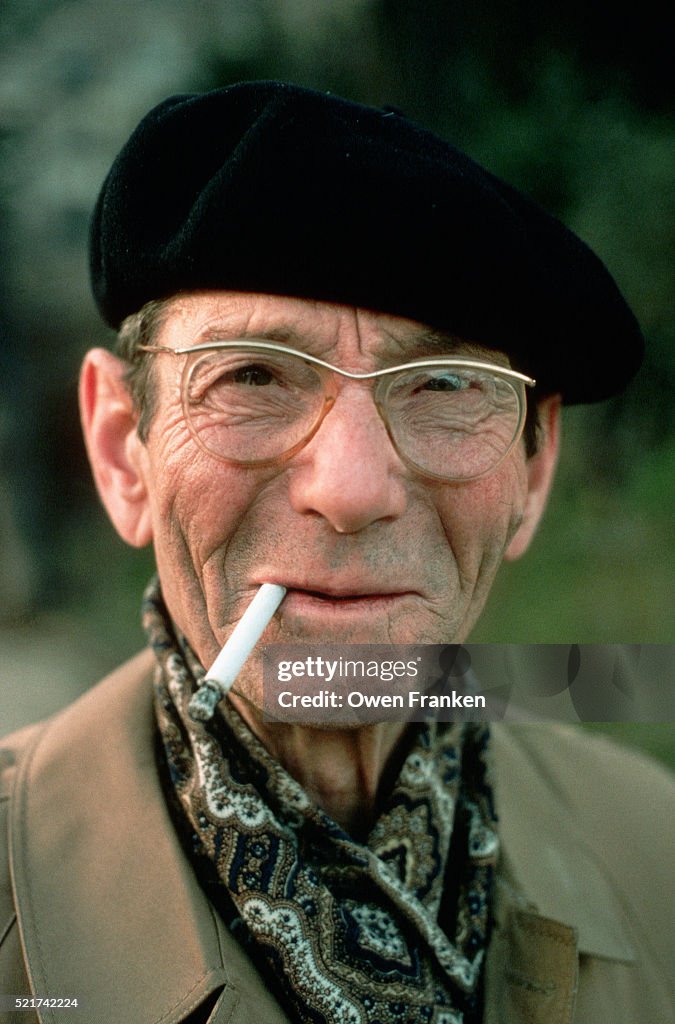 French Man Wearing Beret and Smoking Cigarette