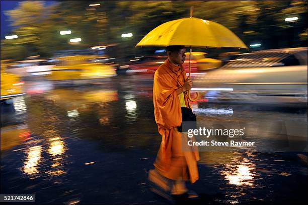 buddhist monk walking on chowringhee road - bengal city stock pictures, royalty-free photos & images