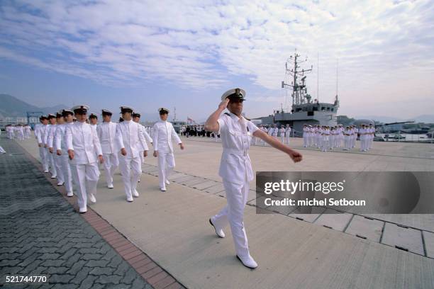 sailors marching in white dress - flotte stock-fotos und bilder