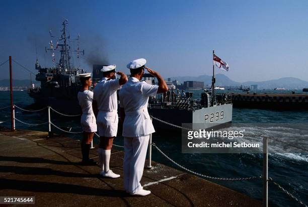 sailors saluting departing warship - naval bases stock pictures, royalty-free photos & images