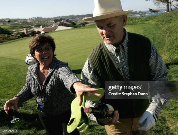 Fan Norma Glaser of Concord, California tries to retrieve her bottle of wine from actor Bill Murray during the first round of the AT&T Pebble Beach...