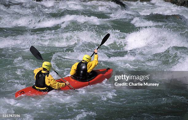 kayakers in a 2 person kayak (topoduo) navigate a rapid on the south fork of the payette river in idaho. mr: j1- wink jones, m4-kari miller - payette river stockfoto's en -beelden