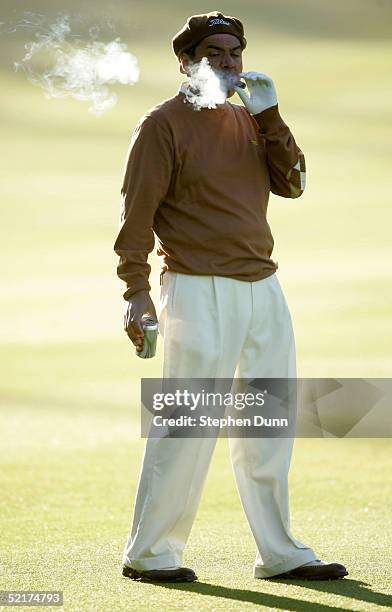 Comedian George Lopez puffs on a cigar on the first fairway during the first round of the AT&T Pebble Beach National Pro-Am on February 10, 2005 at...