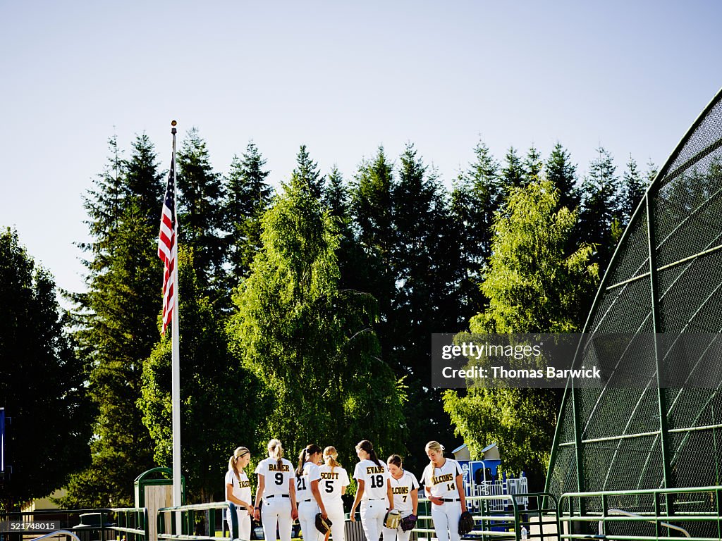 Softball team in discussion before taking field