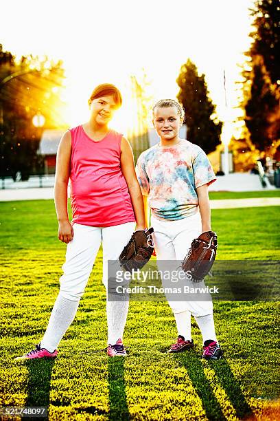 Portrait of two young smiling softball teammates